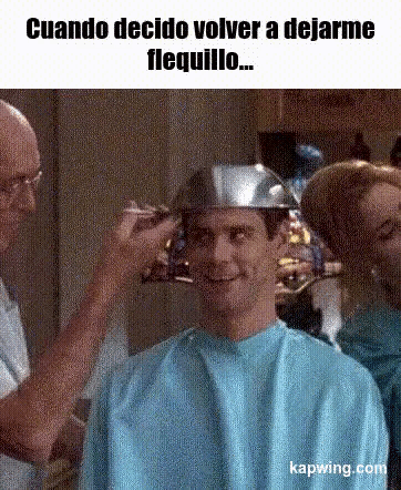 a man is getting his hair cut by a barber while wearing a helmet .