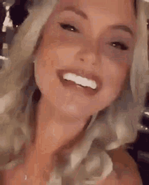 a close up of a woman 's face with a piercing in her mouth .