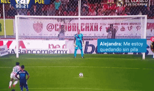 a soccer goalie stands in front of a banner for bancomer mx