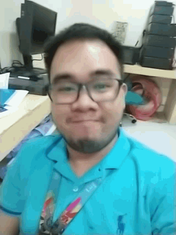 a man with glasses and a lanyard around his neck that says ' lg ' on it