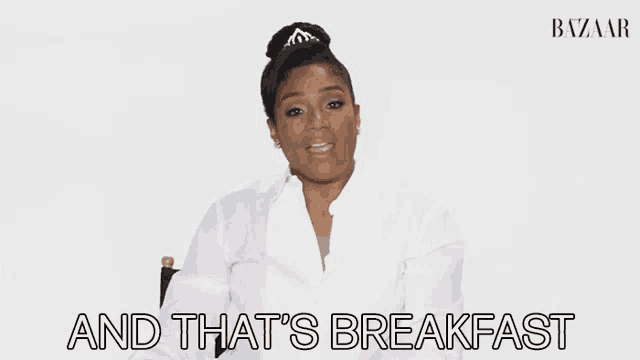 a woman in a white shirt is sitting in a chair with the words and that 's breakfast below her