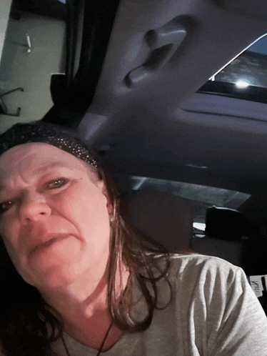 a woman sitting in the back seat of a car