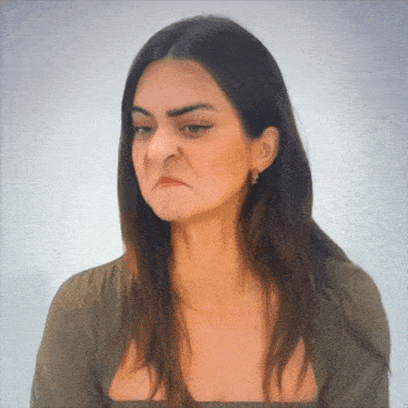 a woman making a funny face with her eyes closed