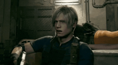 a man with blonde hair is holding a gun in a room