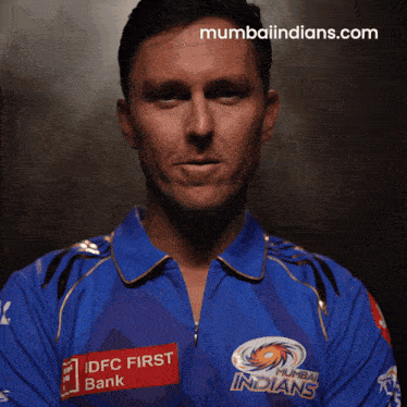 a man wearing a blue shirt that says indians on it