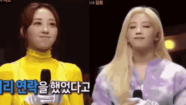 two women are standing next to each other in front of a microphone . one of the women is wearing a yellow costume .