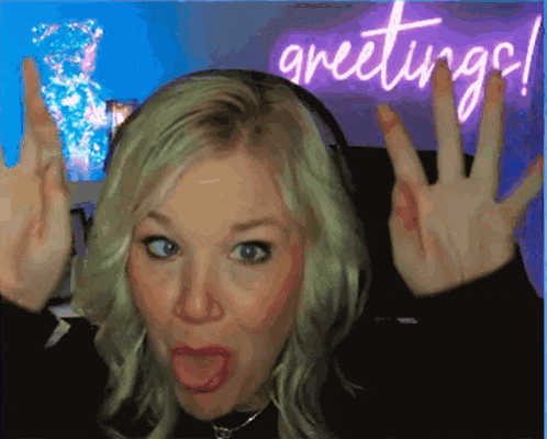 a woman is making a face in front of a sign that says greetings