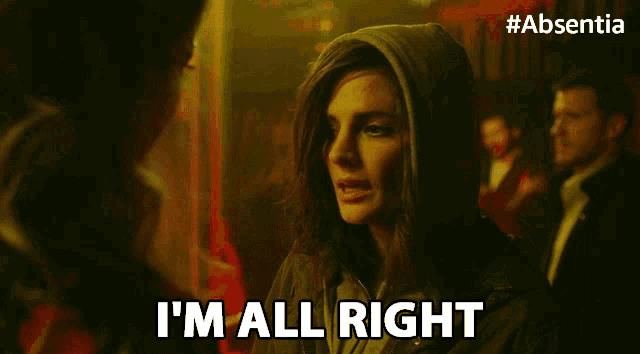 a woman in a hooded jacket is saying i 'm all right