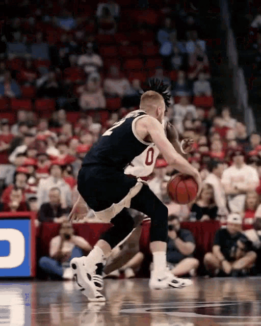 a basketball player with the number 0 on the back of his jersey