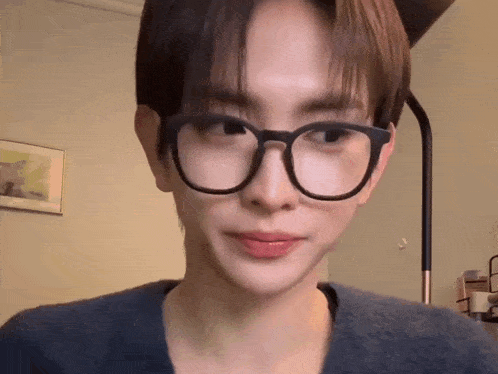 a close up of a person wearing glasses