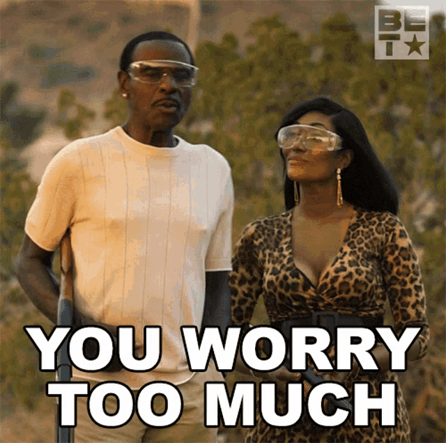 a man and a woman are standing next to each other and the woman is wearing a leopard print dress