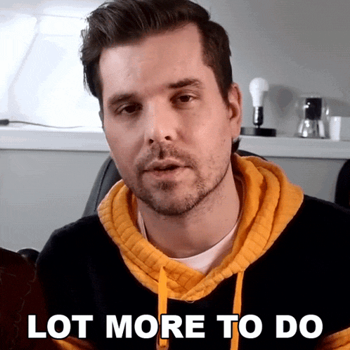 a man wearing a yellow and black hoodie says " lot more to do "
