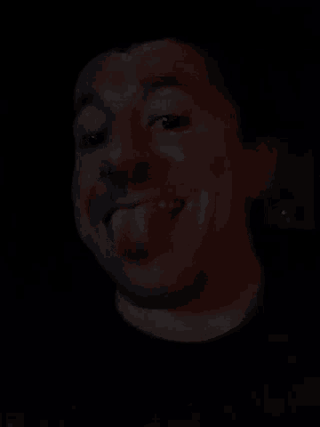 a close up of a person 's face with a red spot on it