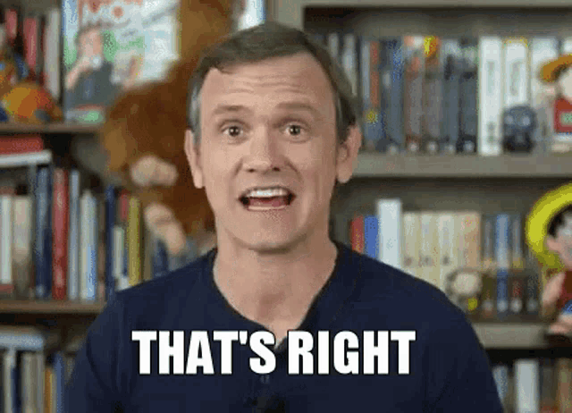 a man is standing in front of a bookshelf with the words `` that 's right '' written on his face .