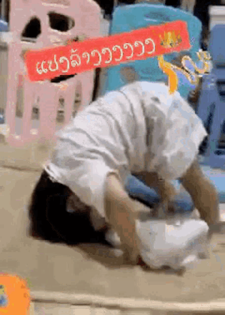 a person is laying on their back on the floor with a sign that says `` i 'm sorry '' .