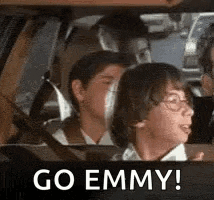 a group of children are sitting in a car with the words `` go emmy ! ''