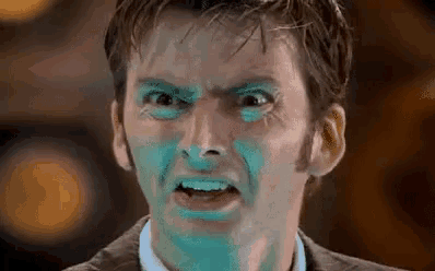 a close up of a man with blue paint on his face .