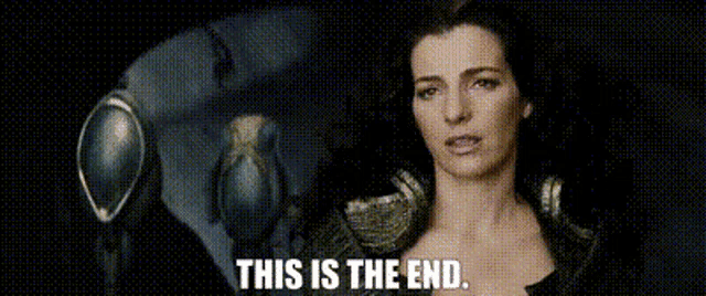 a woman is standing in front of a mirror with the words `` this is the end '' written on it .