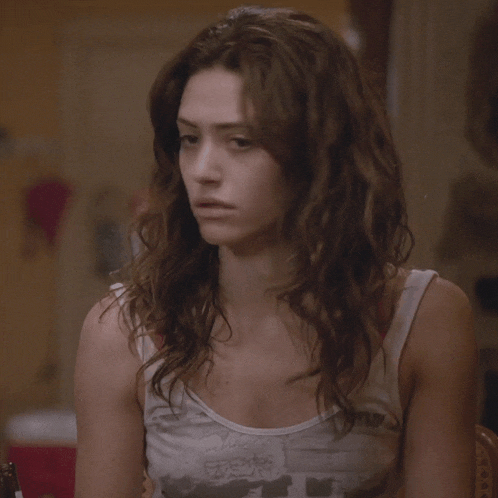 a woman wearing a white tank top with a picture of a man on it