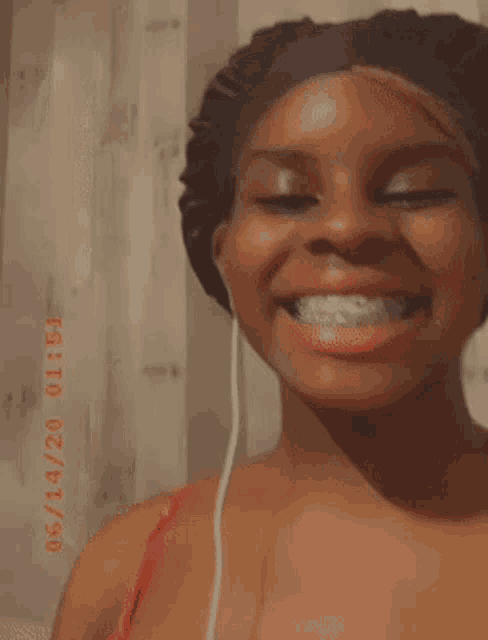 a woman with braces on her teeth is smiling and wearing a bonnet