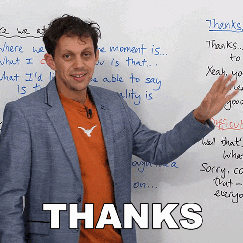 a man is standing in front of a white board with the words thanks written on it