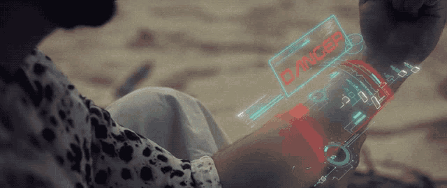 a person 's wrist has a digital display that says danger
