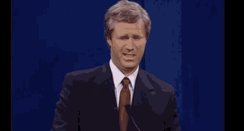 a man in a suit and tie making a funny face