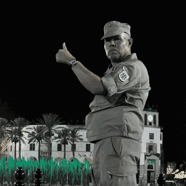 a man in a military uniform giving a thumbs up sign