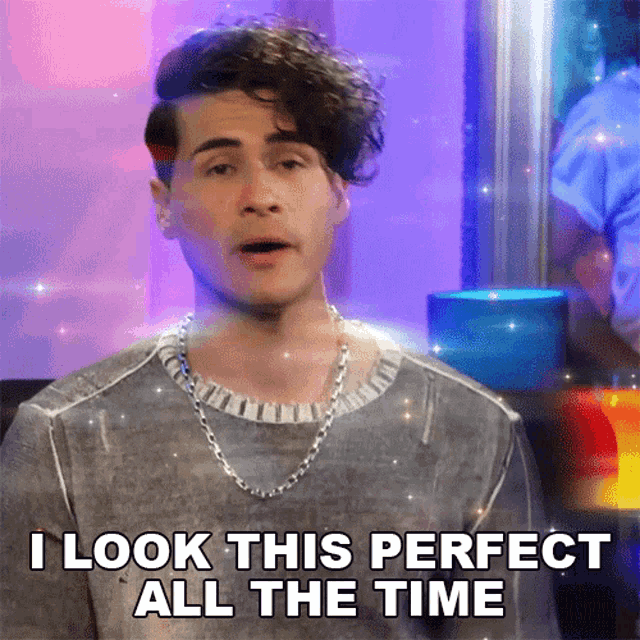 a man with curly hair and a chain around his neck says i look this perfect all the time