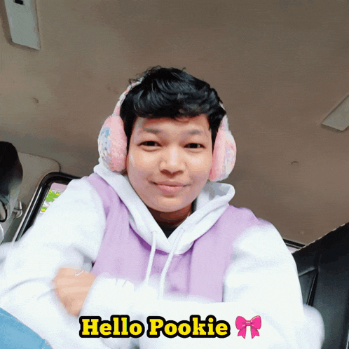 a person wearing ear muffs and a purple hoodie with the words hello pookie below them