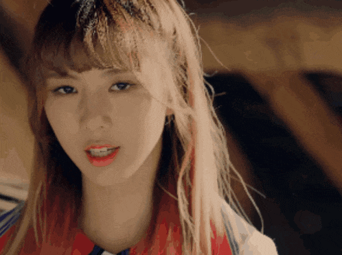 a close up of a girl with red hair and bangs