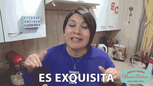 a woman wearing a blue shirt that says es exquisite on it