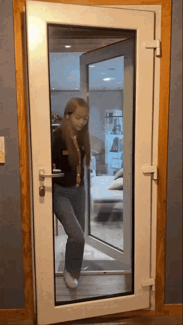a woman is standing in front of a door that has a lock