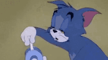 a cartoon cat is holding a stick with a hole in it and making a hole in it .