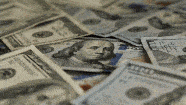 a pile of 100 dollar bills with a picture of benjamin franklin