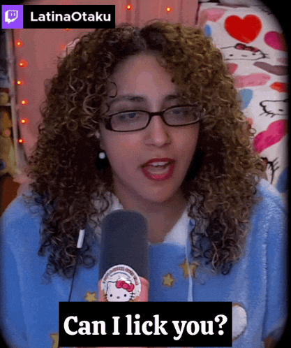 a woman with curly hair is wearing glasses and holding a hello kitty button