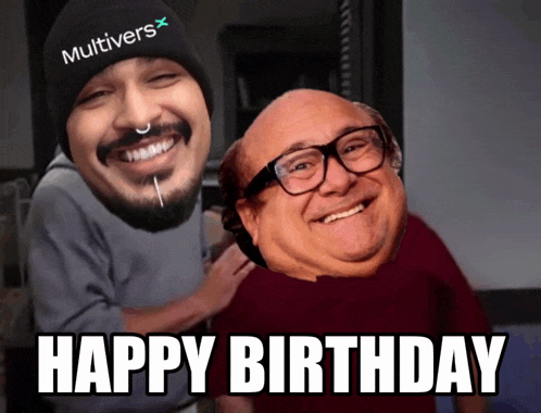 a man wearing a beanie that says multivers on it is smiling next to a man wearing glasses