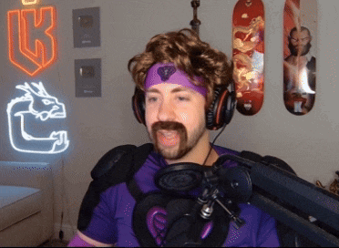 a man wearing headphones and a purple headband with the letter k behind him