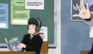 a boy wearing headphones is reading a book in a classroom while a girl waves at him .
