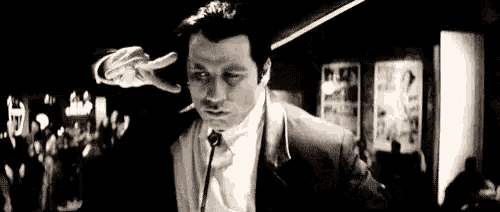 a man in a suit and tie is talking into a microphone .
