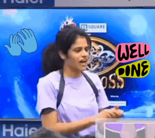 a woman stands in front of a screen that says haier on it