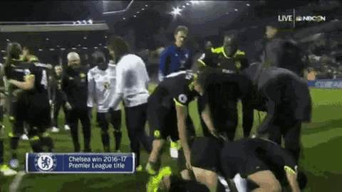 a group of soccer players are kneeling on the field with a banner that says chelsea win 2016-17 premier league title