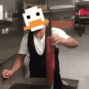 a man in an apron with a duck face on his head