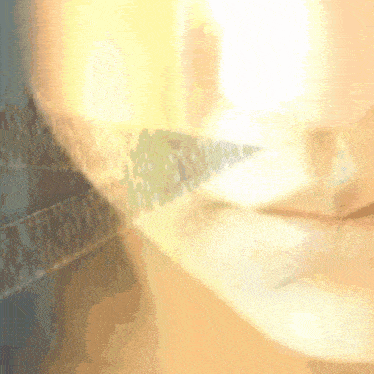 a close up of a person 's face with a blurred background that says ' a ' on it