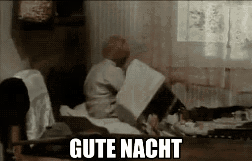 a man laying on a bed with the word gute nacht written on the bottom
