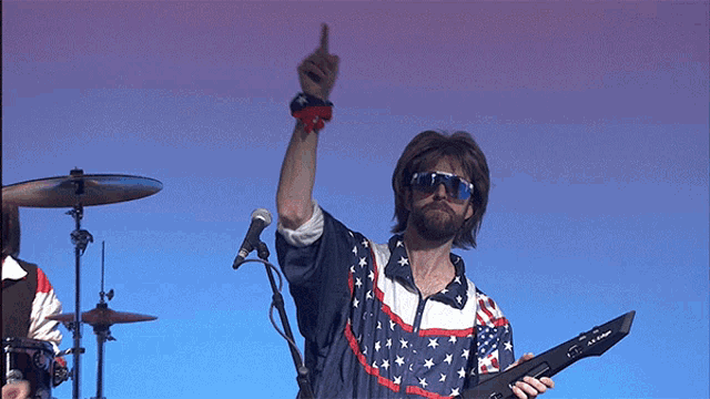 a man in an american flag shirt is holding a keyboard