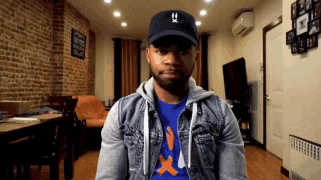 a man wearing a hat that says ' x ' on it