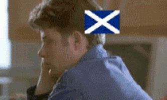 a man with a scottish flag on his head .