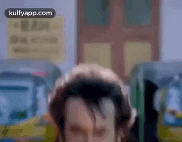 a blurry picture of a man 's face with a sign in the background that says ram .