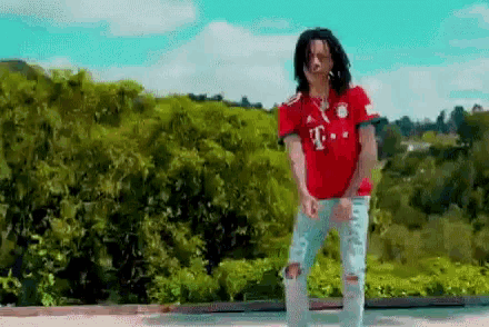 a man wearing a red t-mobile shirt is dancing